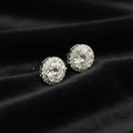 Pair of diamond stud earrings on a black velvet background
